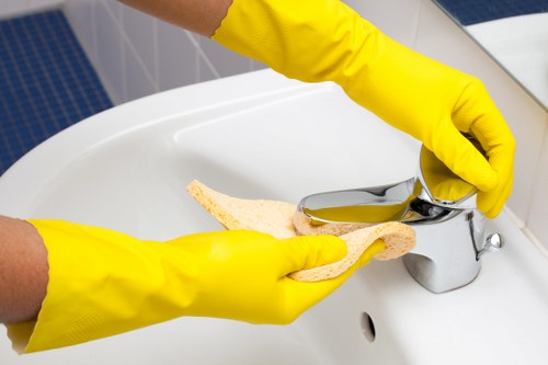 Cleaner working on a range cooker in a Haringey property
